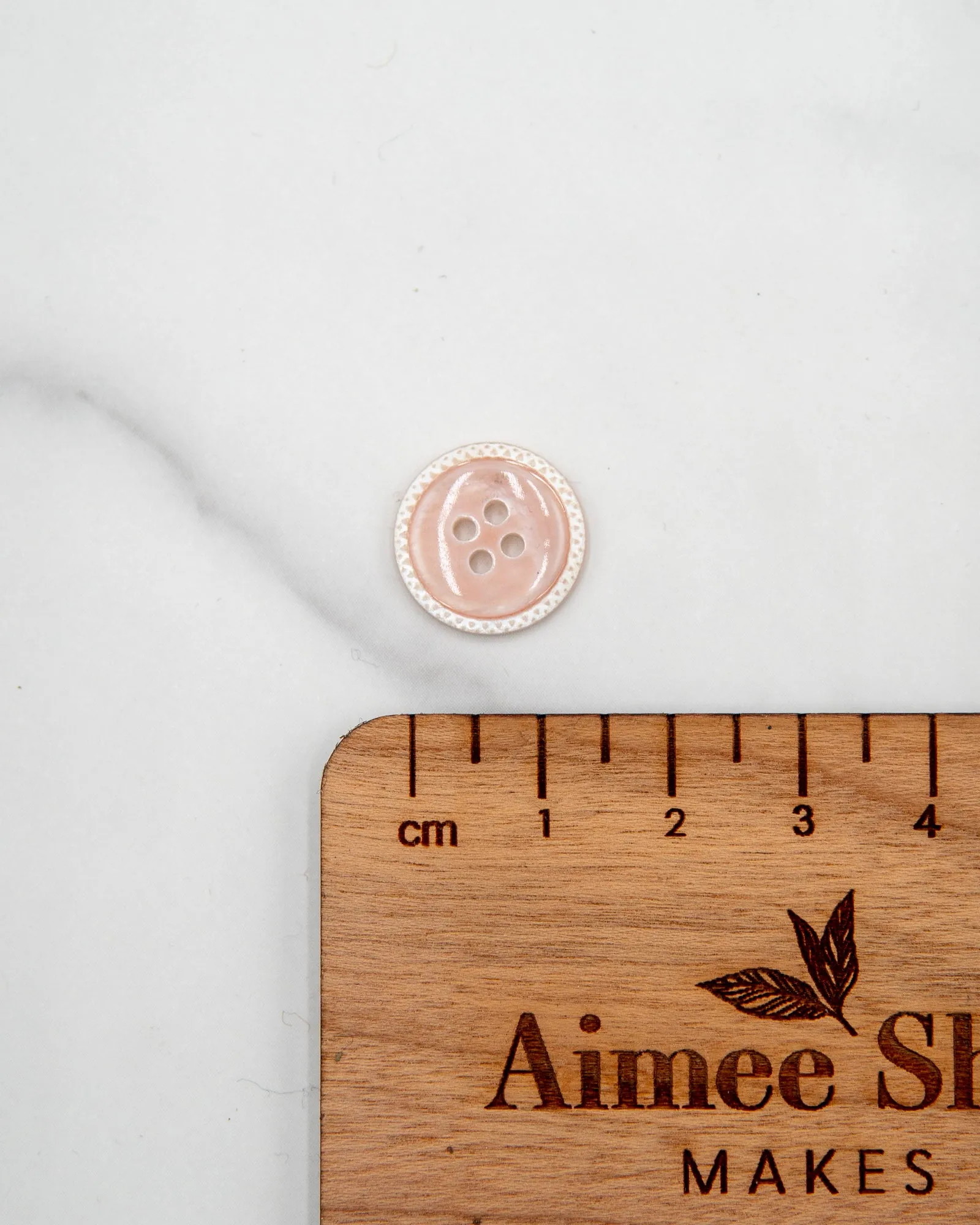 Glossy pale river shell buttons with textured edge