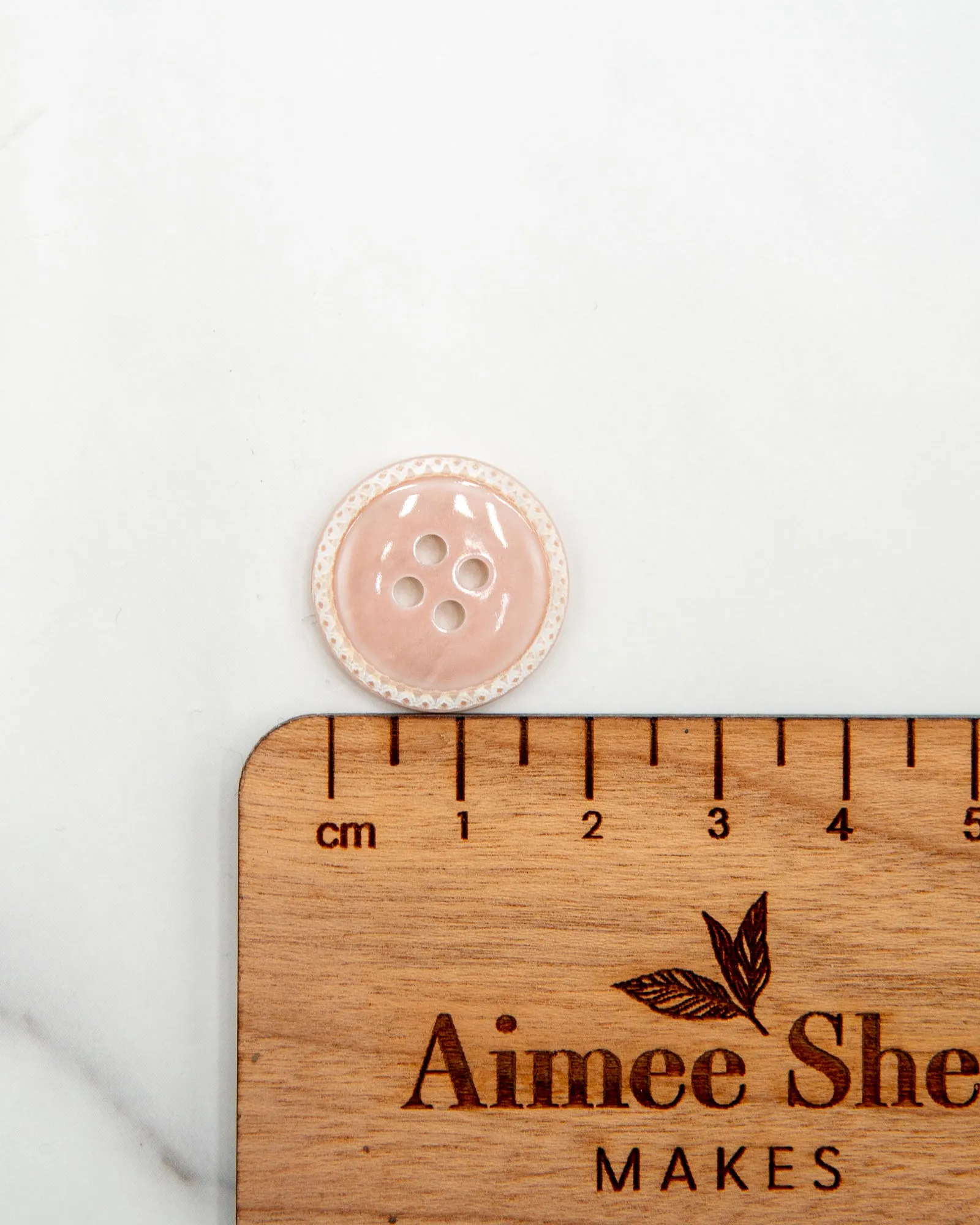 Glossy pale river shell buttons with textured edge