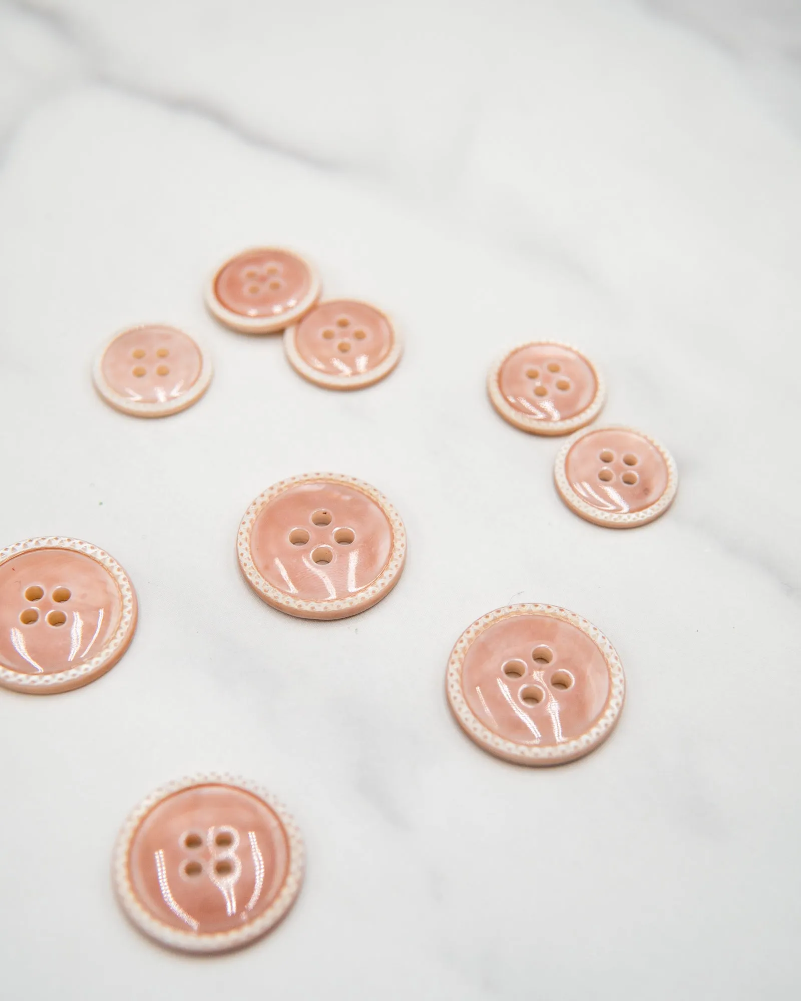 Glossy pale river shell buttons with textured edge